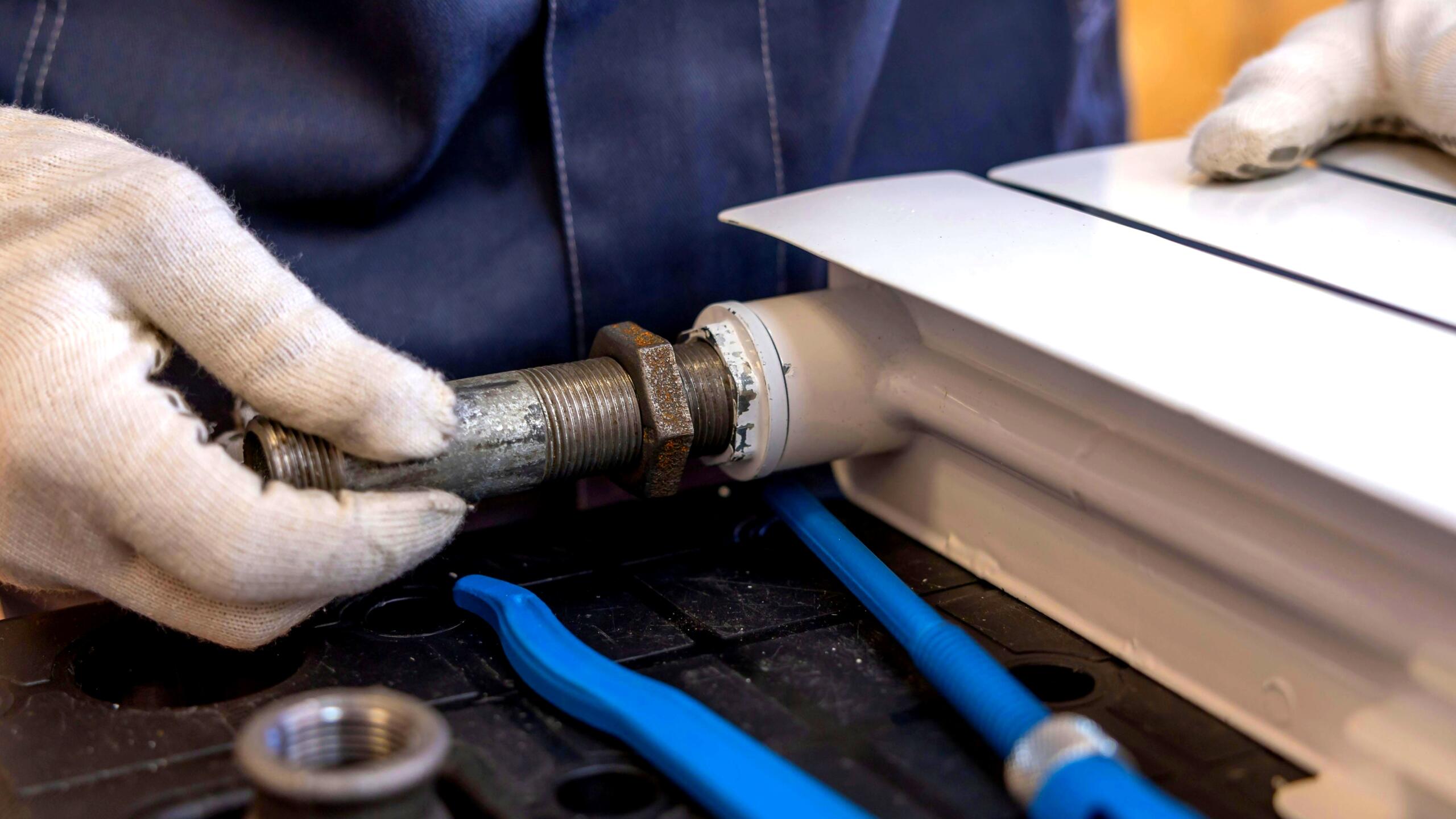 How Palm Beach Gardens Plumbers Tackle Local Geology & Climate Issues Plumber inspecting pipes in Palm Beach Gardens home, palm beach gardens plumbers