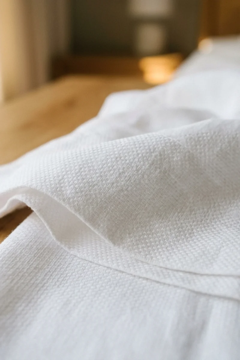 Macro detail of crisp cotton percale weave showcasing breathable interstitial pores